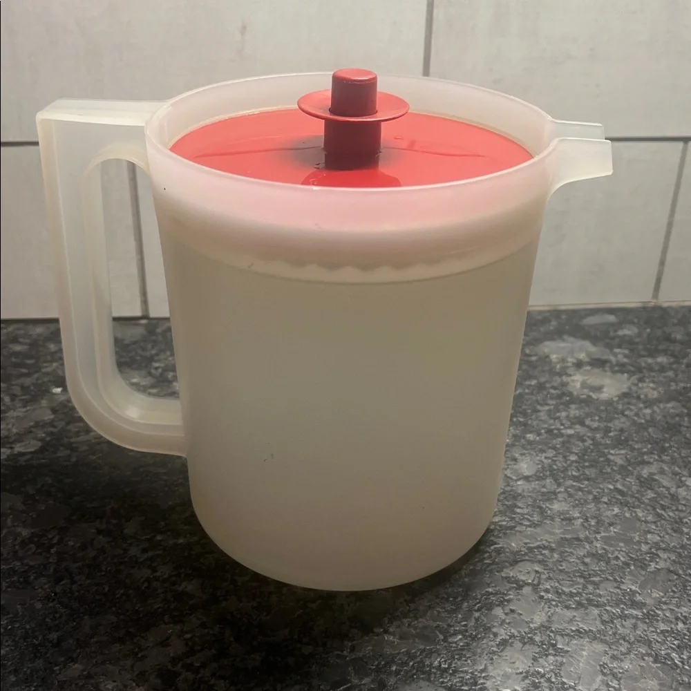 1 1/2 qt semi sheer And Brick Red Plastic Pitcher by Tupperware. Push button lid